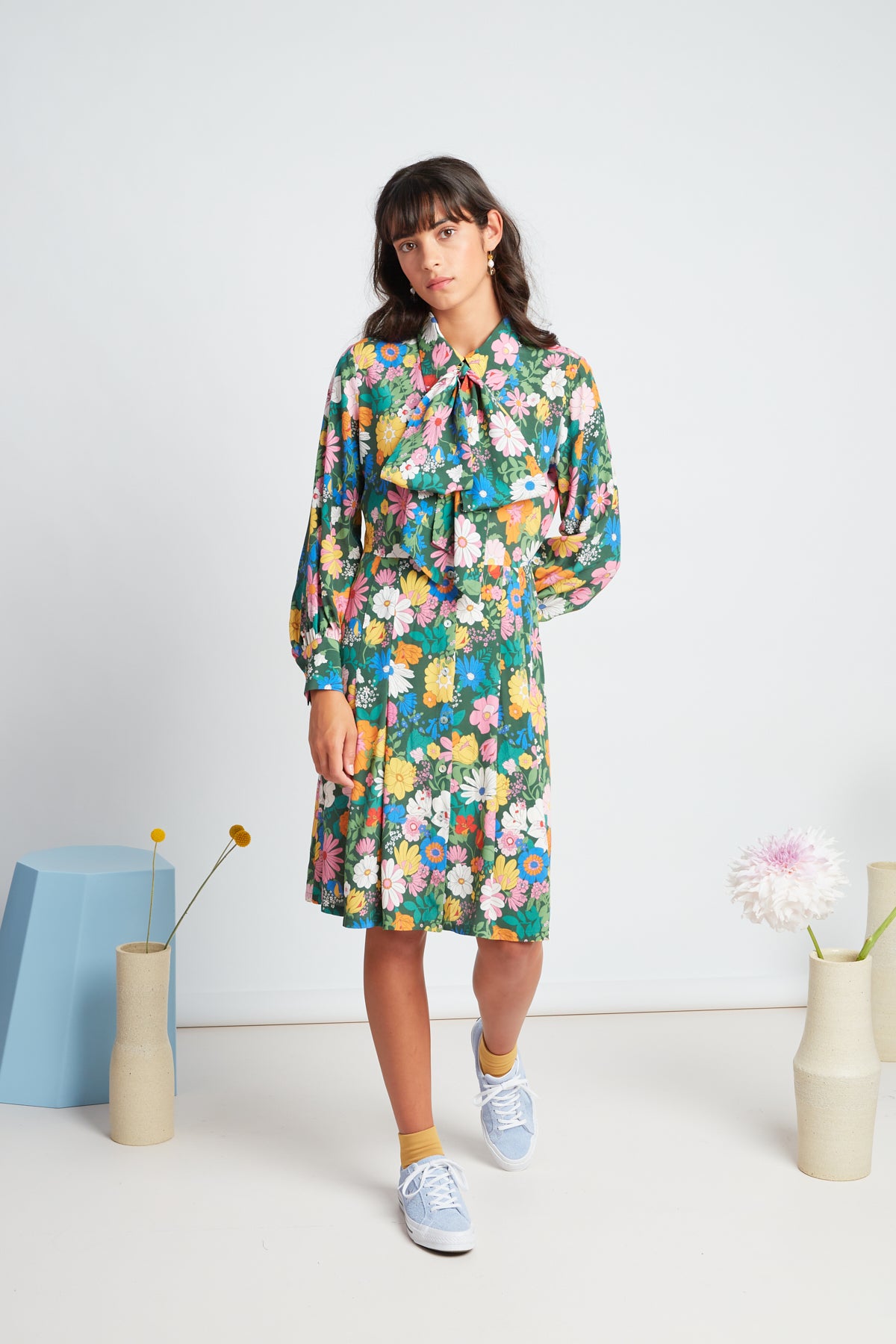 Bouquet dress by twenty-seven names. Long-sleeved shirt dress, with a set waist and dart shaping, gathered sleeves, and an optional big pussy bow accessory.  Custom TSN Botanical print - multi coloured on a green base.